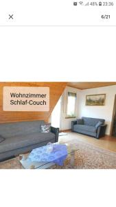 a living room with a couch and a table at 4 Erw. 1 Ki. Ski Entspannung Terasse Ausblick in Schmallenberg