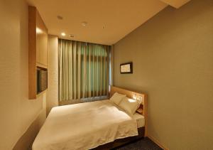 Postel nebo postele na pokoji v ubytování Welina Hotel Premier Nakanoshima EAST