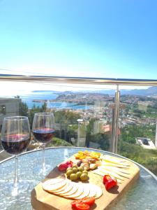 una mesa con dos copas de vino y comida. en Villa Matanovi Dvori, en Podstrana