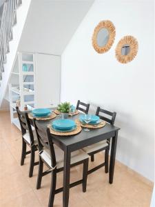 a dining room with a black table and chairs at Silver Ocean Puerto Lajas by Sea You There Fuerteventura in Puerto de las Lajas