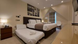 
Ein Bett oder Betten in einem Zimmer der Unterkunft London Star Hotel
