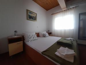 Posteľ alebo postele v izbe v ubytovaní Apartmani Tomić