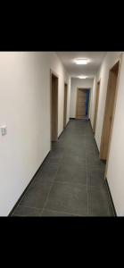 an empty hallway with doors and a tile floor at SD-Apartment in Spielberg
