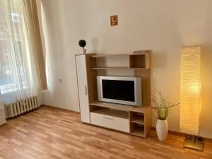 a living room with a tv on a shelf at Apartment Insat in Szczecin
