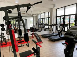 a gym with several treadmills and cardio machines at Siri Residence Bowin in Ban Phan Sadet Nai