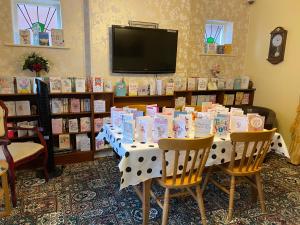a table with books on it in a room at The Homestar in Skegness