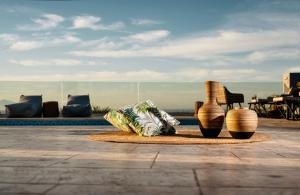 a group of vases sitting on a rug next to a pool at Villa Venia in Tragaki
