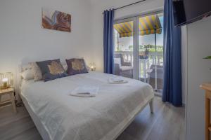 a bedroom with a bed with two towels on it at Apartments Domic in Banjole