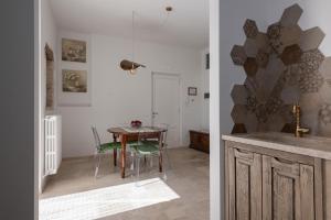 a kitchen and dining room with a table and chairs at Quercus in Alberobello