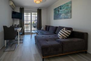 a living room with a couch and a desk at Apartments Domic in Banjole