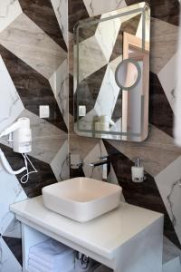 a bathroom with a white sink and a mirror at B1villa in Srima
