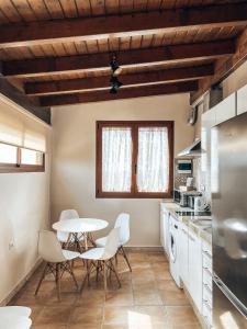 a kitchen with a table and chairs in a room at Suite Vistas al Mar in Puerto del Rosario