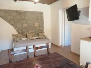 a living room with a couch and a tv at B&B ANDEMAR Rooms in Satriano di Lucania