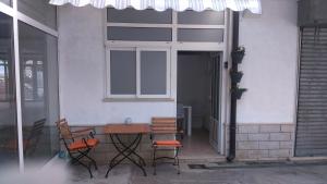 a table and chairs on a patio with a window at Swiss holiday 4 in Split