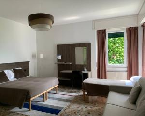 Postel nebo postele na pokoji v ubytování Hotel Loveno + 37 fotografií