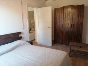 a bedroom with a bed and a wooden cabinet at B&B ANDEMAR Rooms in Satriano di Lucania