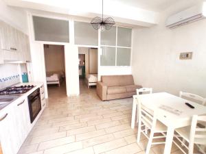 a kitchen and living room with a table and a couch at Tenuta Marga in Agnone