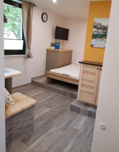 a small room with a bed and a desk at Apartments Helena Kranjska Gora in Kranjska Gora