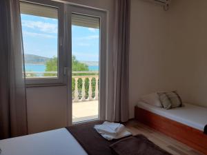 Posteľ alebo postele v izbe v ubytovaní Apartmani Tomić