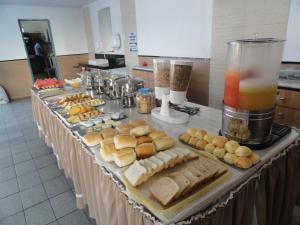 a buffet of food on a table in a kitchen at Pousada São Luiz in Aracaju