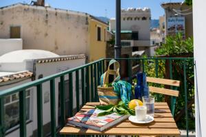 a table on a balcony with a cup of coffee and fruit at Casa Rispoli Praiano in Praiano