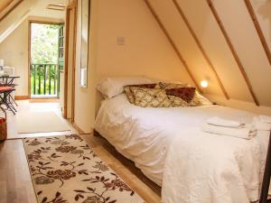 a bedroom with a bed in a room at Milford Tree Tops in Craven Arms