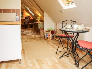 a kitchen with a table and chairs in a room at Milford Tree Tops in Craven Arms
