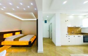 a kitchen and a bedroom with a bed in a room at Onyx Luxury in Ulcinj