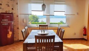 a kitchen and dining room with a table and chairs at Ferienhaus am Seeblick Grill, Garten, Billiard, Dart, Sauna ww-Seeblick in Driedorf