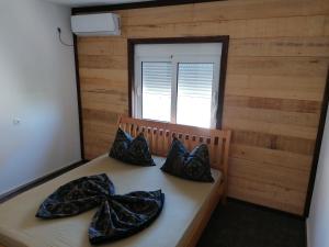a room with a bed with bows on it at Vienna Montenegro Lleshi in Donji Štoj