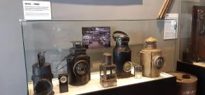 a display case with many bottles on a shelf at Hospedaje Leñas del Tolosa in Las Cuevas