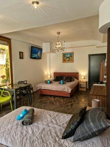 a bedroom with two beds and a dining room with a table at Penelopa Apartments in Ohrid