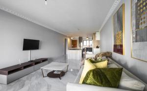 a living room with a couch and a tv at 44 La Pirogue in Ballito