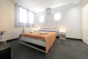 um quarto com uma cama com cobertor laranja e uma janela em LA STANZA IN PIAZZETTA em Santa Margherita Ligure