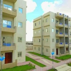 an apartment building with blue balloons in front of it at Tahiti North cost تاهيتي الساحل الشمالي in Al Ḩammām