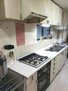a kitchen with a stove and a sink at Within walking distance of Disneyland! - Vacation STAY 11473 in Urayasu