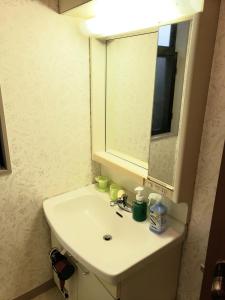 uma casa de banho com um lavatório branco e um espelho. em Within walking distance of Disneyland! - Vacation STAY 11473 em Urayasu
