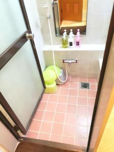 uma casa de banho com piso em azulejo cor-de-rosa e um WC. em Within walking distance of Disneyland! - Vacation STAY 11473 em Urayasu