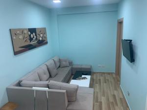 a living room with a couch and a tv at I&S Apartment 3 in Durrës