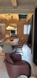 a living room with a dining room table and chairs at Chalet Les 5 Sapins in Les Allues