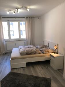 - une chambre avec un grand lit et 2 fenêtres dans l'établissement Augsburg City nah am Hofgarten, à Augsbourg