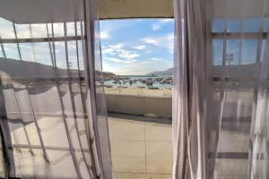 a room with a window with a view of a beach at Orlanova Boutique Hotel in Arraial do Cabo