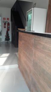 a kitchen with a counter with a christmas tree behind it at Pousada Aloha in Santos