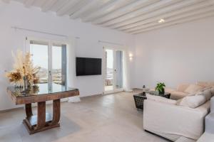 a living room with a table and a couch at DeKo Villa Mykonos in Ano Mera
