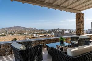 a view from the balcony of a house with a table and chairs at DeKo Villa Mykonos in Ano Mera