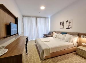 een hotelkamer met een bed en een televisie bij Hotel Clas Mamaia Nord in Mamaia Nord – Năvodari