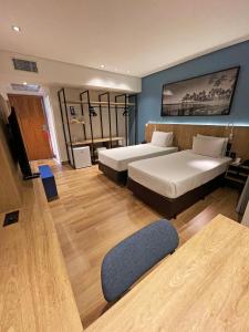 a hotel room with two beds and a couch at Hotel Senac Ilha do Boi in Vitória