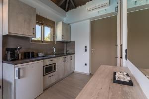 a kitchen with a wooden table in a room at Lighthouse Apartments in Stoupa