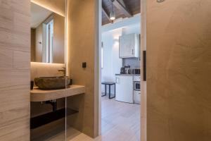 a bathroom with a sink and a counter in a room at Lighthouse Apartments in Stoupa