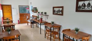 a dining room with wooden tables and chairs at Hotel Veleiro in São Sebastião